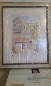 Large framed watercolor house portrait wrapped for a house warming gift.