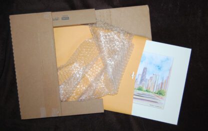 Photo of a matted print fitted into a corrugated free shipping box for transportation.